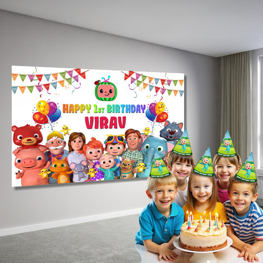 Personalised Cocomelon birthday party backdrop displayed at a 1st birthday decoration setup, JJ Cocomelon party banner behind birthday cake table – BluParty India