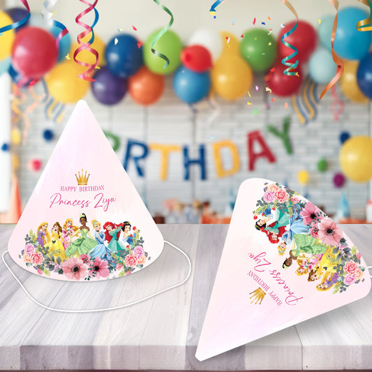 Princess theme personalized birthday hats with glitter crown design and name printed displayed at a girls birthday party celebration with pink and gold balloon decoration India