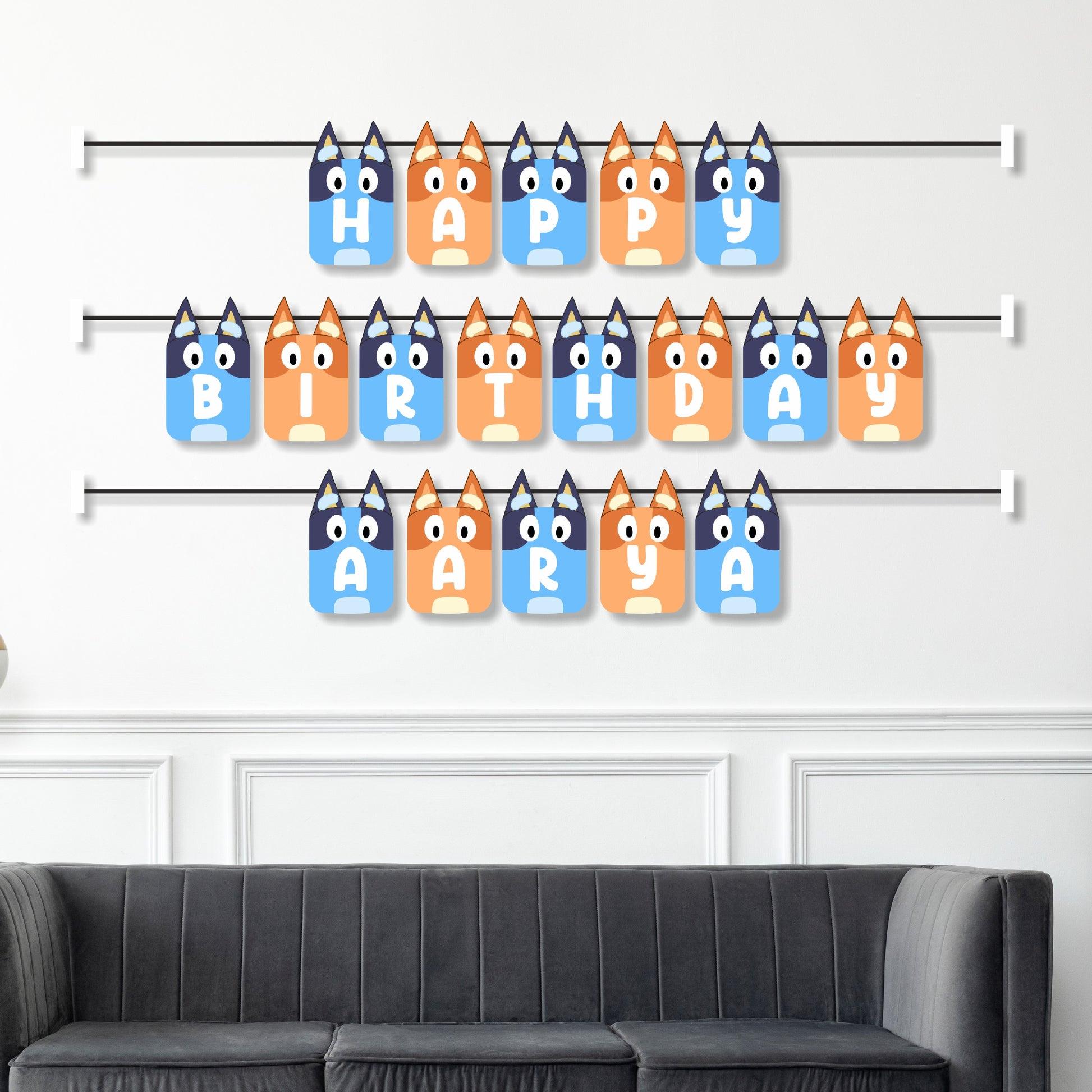 Bluey family themed personalised name bunting displayed as birthday party wall decoration above a cake table, full Heeler family character design – BluParty India