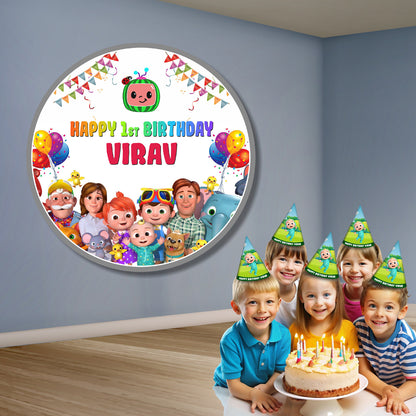 Personalised Cocomelon round backdrop displayed at a 1st birthday party decoration setup, circular Cocomelon party banner on flex print – BluParty India