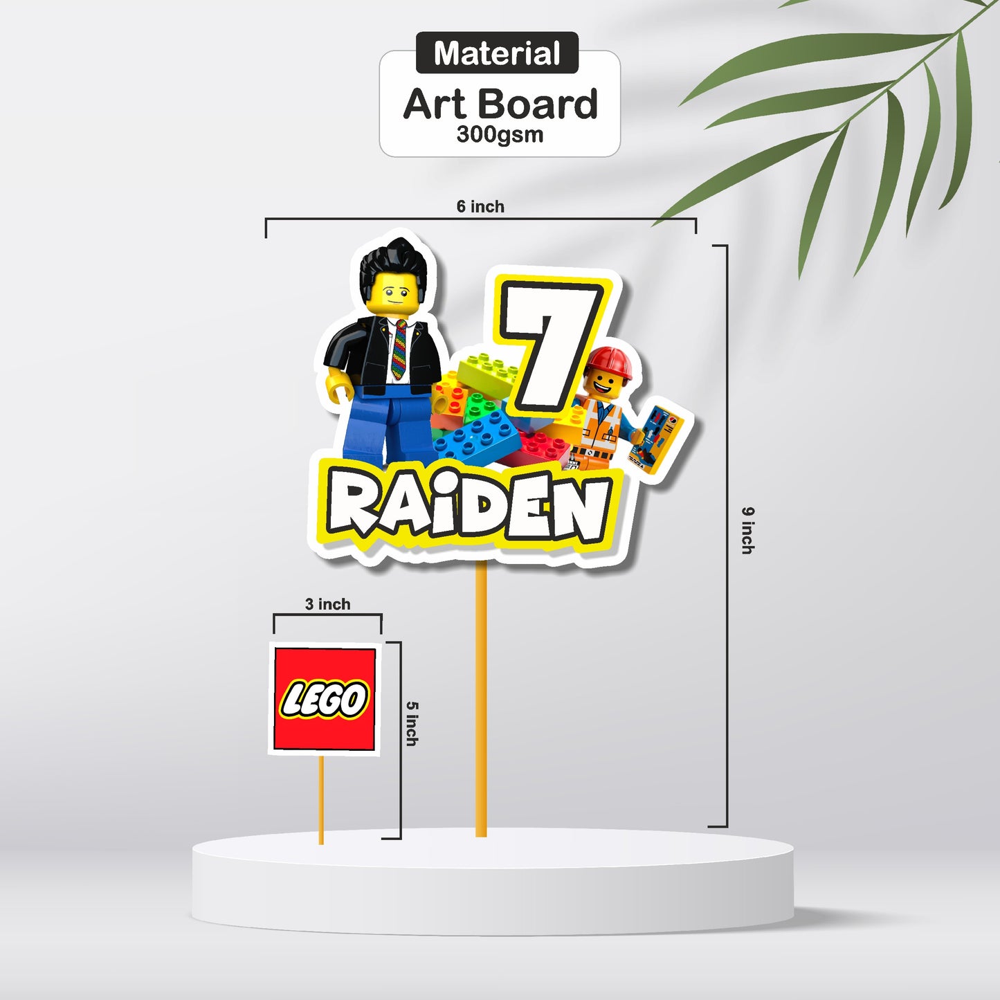 Close-up of a colourful Lego brick customized cake topper showing printed name, event time, venue, and RSVP contact on premium 300GSM artboard