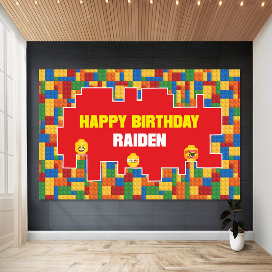 Lego theme birthday backdrop personalized with child's name and age installed on wall at kids birthday party showing vibrant red yellow blue and green brick design by BluParty India
